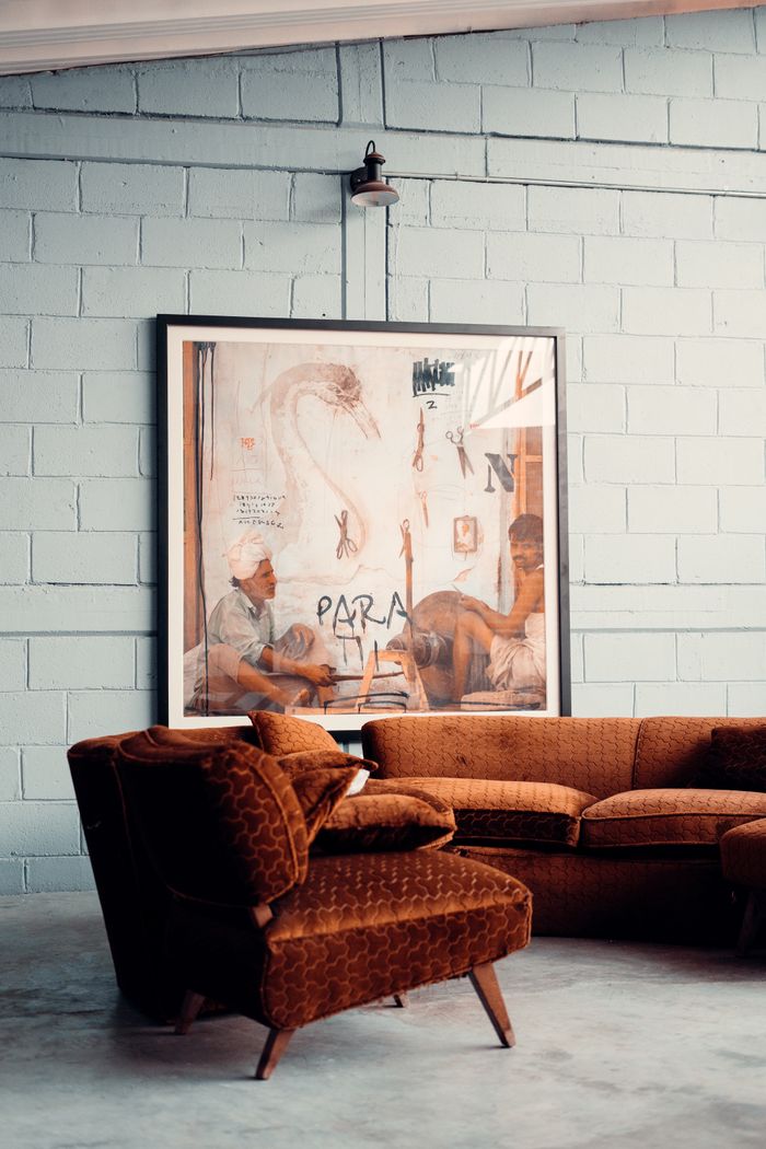 Cozy living room featuring vintage furniture and artistic wall decor in a modern loft setting.
